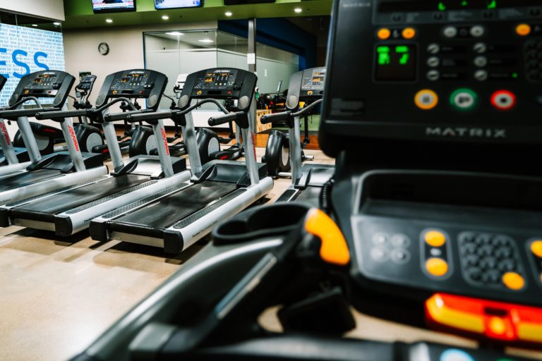 treadmill in an empty gym article maximizing treadmill workouts