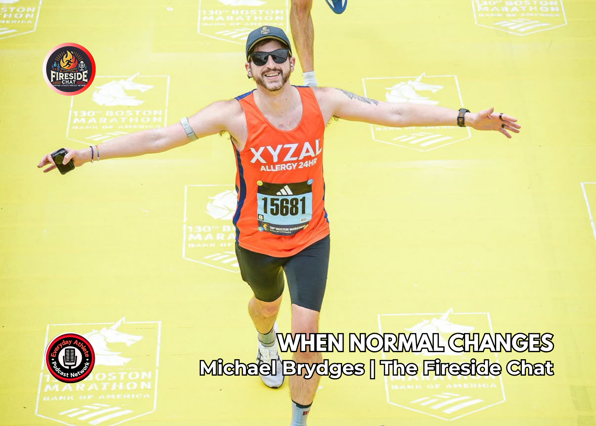 Michael Brydges smiling while running across the 2026 Boston Marathon finish line with his arms extended.