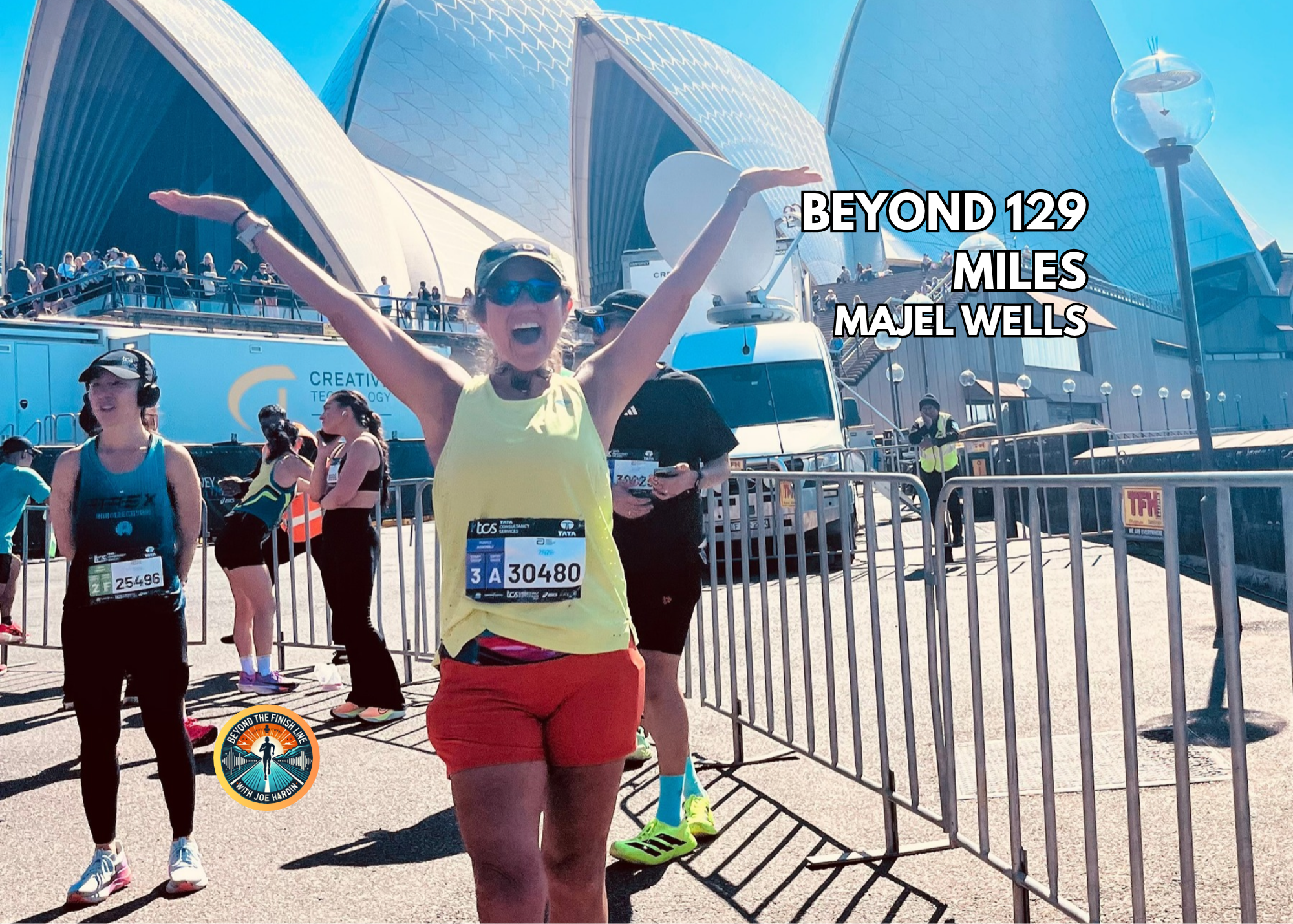 Majel Wells celebrating at the Sydney Marathon with the Sydney Opera House behind her