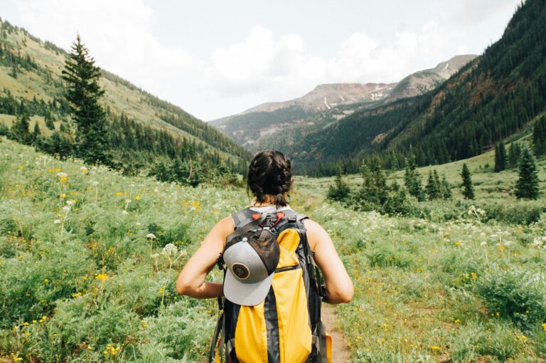 Athlete hiking a mountain trail during the triathlon offseason as a form of active recovery and cross-training.