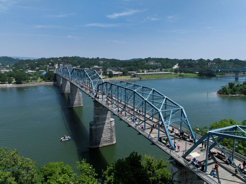 Athletes cross the Tennessee River on a blue bridge during Ironman Chattanooga, where Wendy Mader reflected on stepping away from Ironman racing.